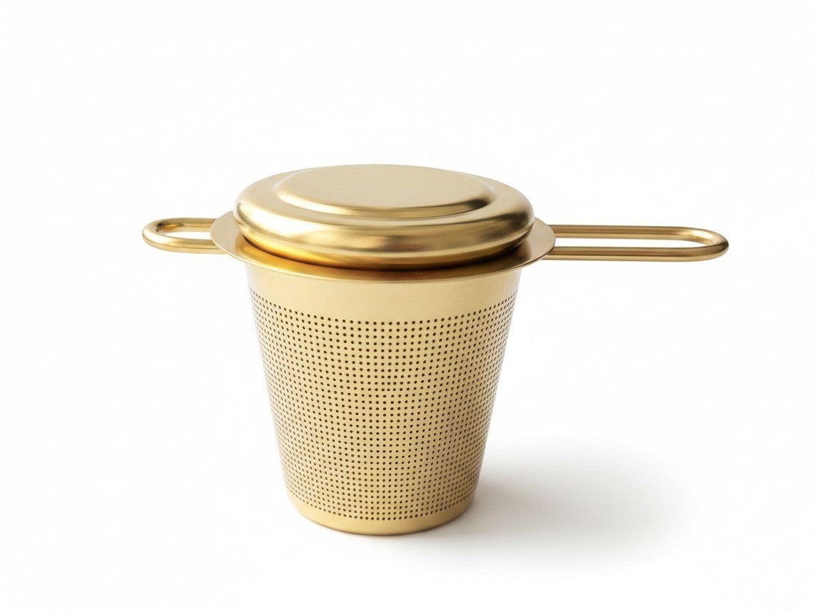 Wandering Leaf Co gold fine-mesh tea infuser with a versatile lid that doubles as a coaster on a white background.